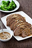 Sliced Meatloaf on a Serving Plate with Mushroom Gravy and Broccoli