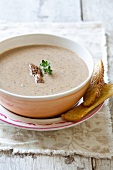 A Bowl of Mushroom Soup with Morel Garnish and Crostini