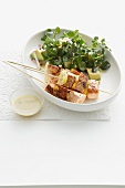 Plate of salmon skewers and salad
