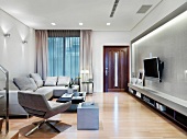 Light gray living room suite, wall mount TV and indirect lighting
