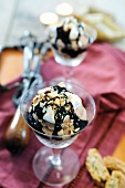 Milk chocolate mousse topped with whipped cream, chocolate sauce and chopped almonds