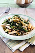 Giant couscous salad with grilled chicken, peas and green beans