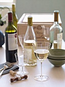 Variety of Wine in Bottles; Wine Glasses; Corkscrew