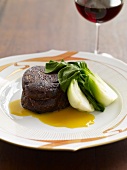 Beef Fillet with Baby Bok Choy; Glass of Red Wine
