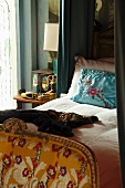 View of antique bed with embroidered cushion