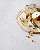 Fruit, cheese and nuts on wooden board