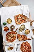 Overhead view of table with pizzas