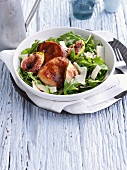 Bowl of pork medallions with salad