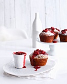 Plates of raspberry muffins and jam
