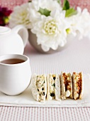 Sliced sandwiches with cup of tea