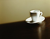 An espresso cup on a brown surface