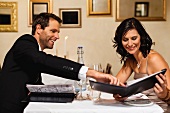 Couple examining menus in restaurant