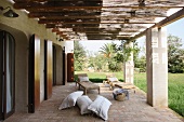 Terrace of Mediterranean house with pergola on concrete pillars with view of garden