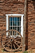 Window in Stone Building With Wagon Wheel