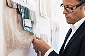 Businessman examining fabric swatches