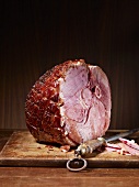 Roast ham with bones on a chopping board