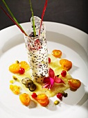 Pina Colada mousse in a sugar wafer on a bed of pineapple carpaccio and a kumquat ragout