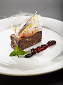 Walnut brownie with baked apple ice cream in a sugar basket served with port wine berries
