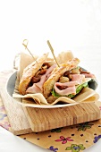 A ham and lettuce baguette with marinated mushrooms