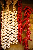 Garlic Braids and Strings of Red Peppers on Market Wall in Laguardia, Spain