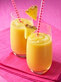 Two glasses of pineapple and mango smoothies