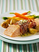 Salmon fillets wrapped in ham with new potatoes