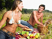 Couple having a picnic in a field