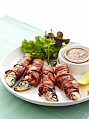 Roasted sardines stuffed with orange slices and wrapped in bacon