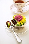 Flower Cupcake with a Scoop on a Spoon; Cup of Tea