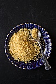 Dried Lemon Zest on a Blue Plate with a Spoon