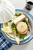 Salad with chicory, apple slices, Camembert and a Dijon dressing