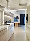 Freestanding kitchen counter in front of a wide passage with a view of a dining table