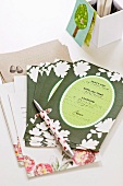 Invitation cards and pen in front of white cardboard storage box