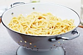Cooked Spaghetti in a White Metal Strainer