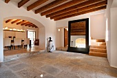 Tile floor and wooden ceiling beams in entry of Spanish villa