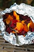 Vegetables wrapped in tin foil for grilling