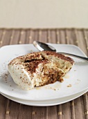 Tiramisu on a plate with a spoon