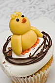 A cupcake decorated with and Easter chick
