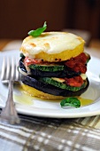 Baked polenta and mixed vegetable stack topped with cheese