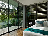 Floor to ceiling windows in modern bedroom