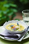 Organic vegetable soup with edible flowers