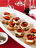 Crostini topped with strawberries, brie and balsamic cream