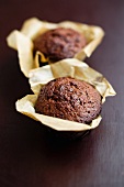 Two chocolate muffins in paper