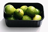 Limes in a black plastic box