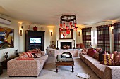 Octagonal living room with open fireplace, sofas, coffee table and TV (Villa Octavius, Lefkas, Greece)