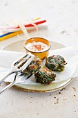 Spinach and pine nut cakes with a dip