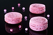 Pink macaroons on a shiny suface