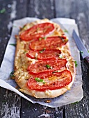Pizza topped with plum tomatoes