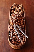 Hazelnuts in a basket with a nut cracker