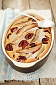 Pear and plum clafouti in a baking dish